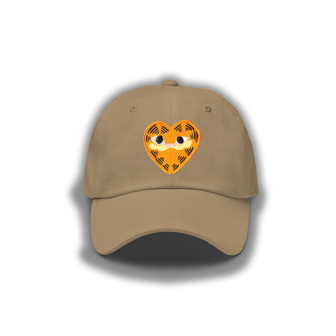 A khaki unisex dad hat featuring a heart-shaped orange patch depicting Garfield the cat.