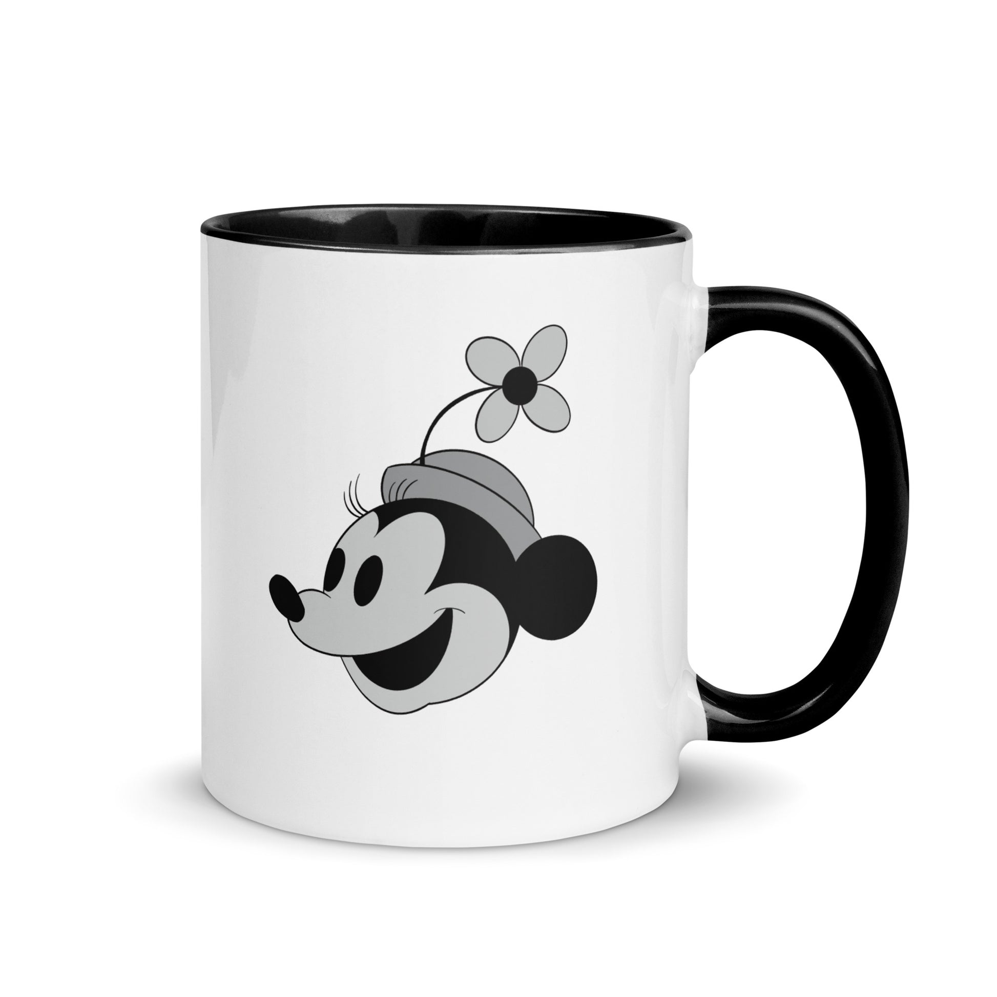 A white coffee mug with black and white images of Mickey and Minnie Mouse.